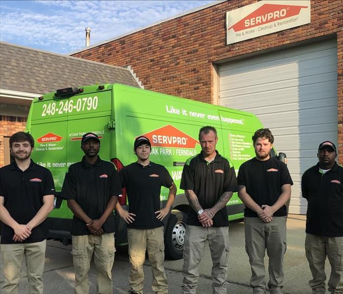 SERVPRO crew standing in front of their SERVPRO truck